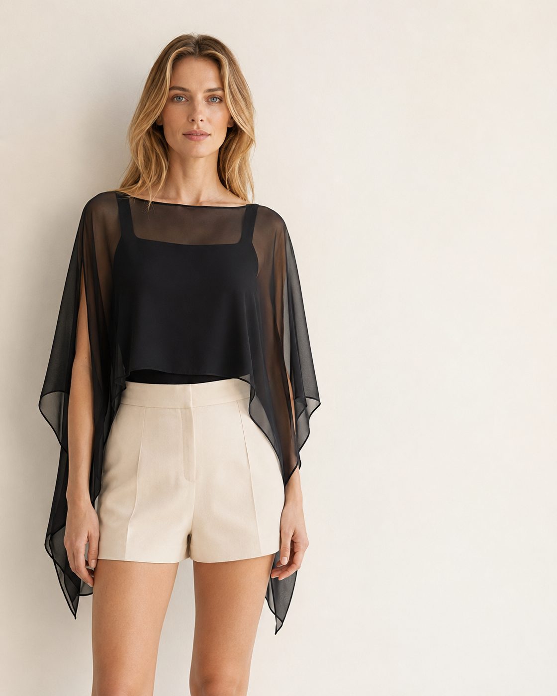 Aura cape poncho blouse worn over a black top